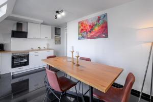 沃尔姆斯Nibelungen Apartments的厨房配有木桌和椅子
