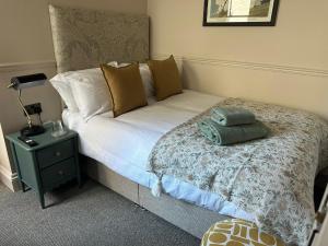 赛伦塞斯特The Golden Cross的一间卧室配有一张带绿色枕头的床
