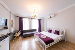 伊斯坦布尔The Frame Hotel & Suites的卧室配有白色床和紫色枕头