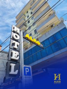 斯库台Alko Hotel Shkoder的建筑一侧带有黄色休息室的酒店标志