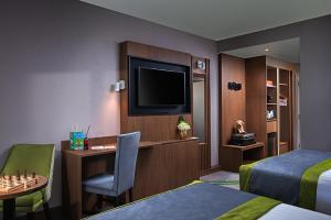 柯罗格伦都柏林机场卡尔顿酒店的酒店客房配有一张床、一张书桌和一台电视。