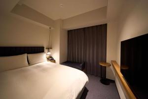 东京Hotel Resol Stay Akihabara的酒店客房,配有床和电视