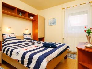 BadacsonyHoliday Home Toth - BAC109 by Interhome的一间卧室配有一张带蓝白色毯子的床