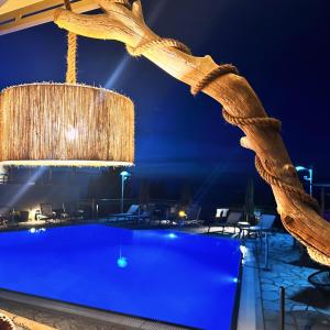 雷夫卡达镇塞米勒米斯酒店的游泳池的吊灯在晚上悬挂