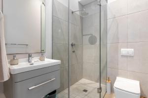 开普敦Top Floor 2 Bedroom Apartment Ocean Views, parking的带淋浴、盥洗盆和卫生间的浴室