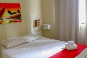 福塔莱萨El Dorado Hotel Fortaleza的卧室配有一张带红色毯子的白色床