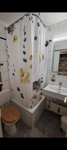 慕尼黑Jezza Apart Suite的浴室设有鲜花和淋浴帘。