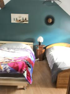 贝热尔莱韦蒂Maison de 3 chambres avec jardin clos et wifi a Bergeres les Vertus的一间卧室设有一张床和蓝色的墙壁