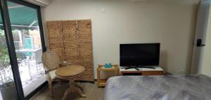 香港海悠居的一间卧室配有一张床、一台电视和一把椅子