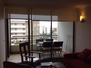 维纳德马Reñaca Park Apartment的阳台设有带桌椅的客厅
