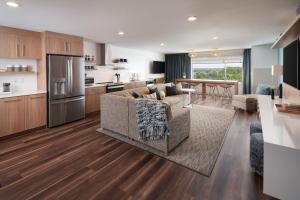 奥兰多Element Orlando International Drive的厨房以及带沙发和桌子的客厅。
