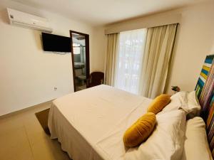 尼泰罗伊Pousada Camarote Itaipu的一间卧室配有一张带黄色枕头的床。