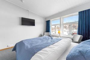 灵塞德林赛迪特吉斯特加德酒店的一间卧室设有一张床、一台电视和窗户。