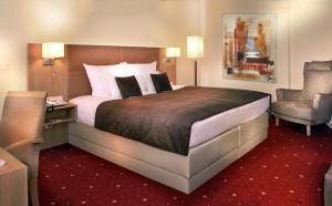 不莱梅祖尔帕斯特贝斯特韦斯特酒店的酒店客房带一张大床和一把椅子