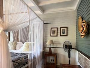 阿鲁沙Mount Meru Game Lodge & Sanctuary的一间卧室,卧室内配有一张天蓬床