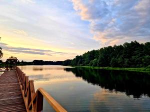 RosnowoOśrodek nad jeziorem - Radew Rosnowo的享有河流和木桥的景色