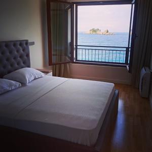 佩特罗瓦纳莫鲁Mar Azul Apartments Petrovac的一间卧室设有一张大床,享有海景