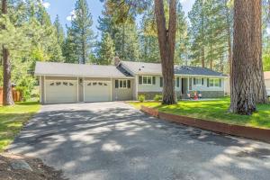 特拉基Truckee Mountain Retreat Family-Friendly 3BR-2BA的一个带车库和车道的房子