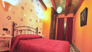 阿维拉Hotel Casa Rural SPA La Villa的一间在房间内配有红色床的卧室