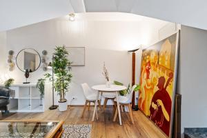 卢森堡Stylish 1BR Apartment in Central Grund的配有桌椅和绘画的房间