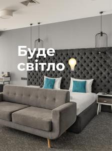 利沃夫City Inn Lviv Smart Hotel的一间卧室配有一张大床和一张沙发
