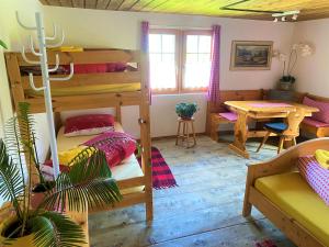 马里克斯Bergpension Battagliahütte的一间带双层床的房间和一间带桌子的用餐室