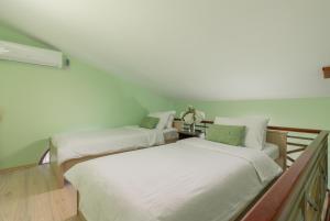 科托尔武科维奇一室公寓酒店的两张睡床彼此相邻,位于一个房间里