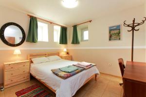 瓦尔纳Nomado Hostel的一间卧室配有一张床、一张书桌和一面镜子