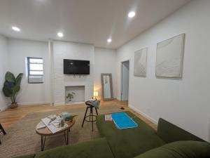 纽约51-1A Renovated 3br 2bath Prime soho的客厅配有沙发和墙上的电视