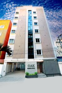 海得拉巴Oak Business Hotel的前面有标志的高楼