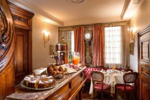 威尼斯Bellevue Luxury Rooms - San Marco Luxury的早餐室配有一张带一盘食物的桌子
