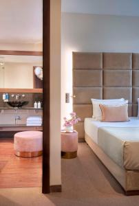 美因河畔法兰克福Flemings Selection Hotel Frankfurt-City的一间带大床的卧室和一间浴室