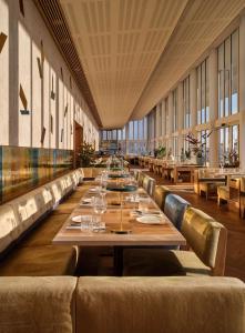 美因河畔法兰克福Flemings Selection Hotel Frankfurt-City的长餐厅,配有长桌子和椅子
