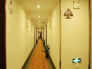 苏州GreenTree Inn Suzhou Shihu Suli Road Express Hotel的走廊上长长的走廊里种有植物