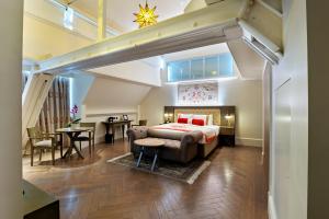 伦敦The LaLit London - Small Luxury Hotel of the World的一间卧室配有一张特大号床和一张桌子