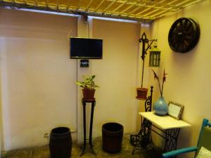 利马维迪纳酒店的客厅配有电视、桌子和桌子。