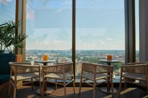 哥德堡Clarion Hotel Draken的客房设有桌椅和大窗户。