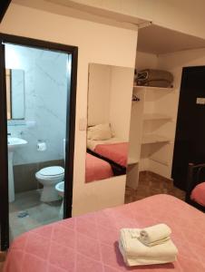 马德普拉塔阿尔蒂科酒店的浴室设有床、卫生间和水槽。