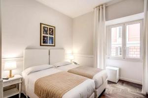 罗马B&B Hotel Roma Italia Viminale的一间白色卧室,配有两张床和窗户