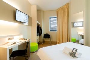 米兰米兰圣西罗住宿加早餐旅馆的客房设有床、书桌和窗户。