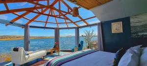 普诺KAY PACHA LODGE lago titicaca All Inclusive的一间卧室配有一张床,享有水景