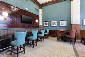 圣路易斯Drury Inn and Suites St Louis Union Station的酒吧设有桌椅和电视