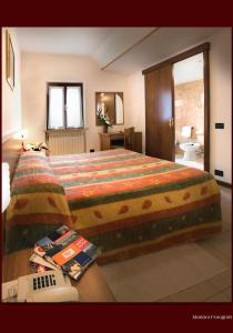 波里奥特米Albergo Il Castellino的一间带大床的卧室和一间浴室