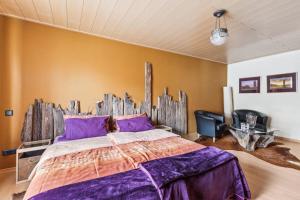 布利斯卡斯特尔Gästehaus Margerite的一间卧室配有一张大床和木制床头板