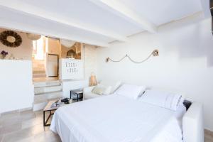 奥斯图尼Casa Zio Piero的白色的卧室配有白色的床和沙发