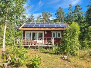 EdsbrukGärdsholmens Skärgårdshemman "Boken"的屋顶上设有太阳能电池板的红色房子