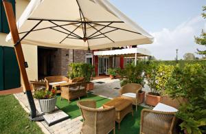 卡普里伽巴尔达酒店的庭院配有桌椅和遮阳伞。