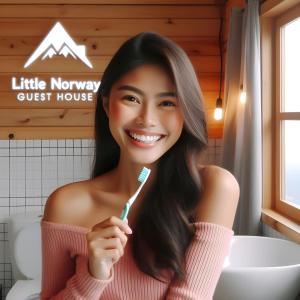 麦克坦Little Norway Guesthouse - Mactan Cebu International Airport的女人在浴室刷牙