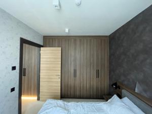 科帕奥尼克Woodside Apartment的一间卧室配有一张床和一个木制衣柜