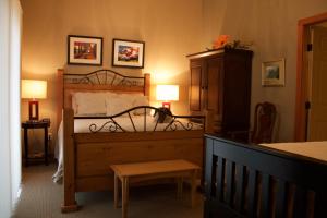 卡斯尔加温德波恩住宿加早餐旅馆的一间卧室配有一张床、一张桌子和两盏灯。